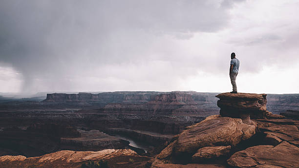 KIITEs in the Forests 5 Man standing on the top of the rock overlooking Canyonlands enjoying the vast landscape view.
