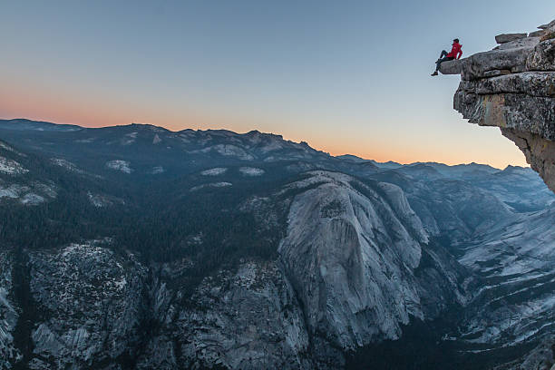 KIITEs in the Forests 6 Adventurer sitting at the summit of the top Half Dome in California. At his feet the precipice and the wonderful views accompany him.