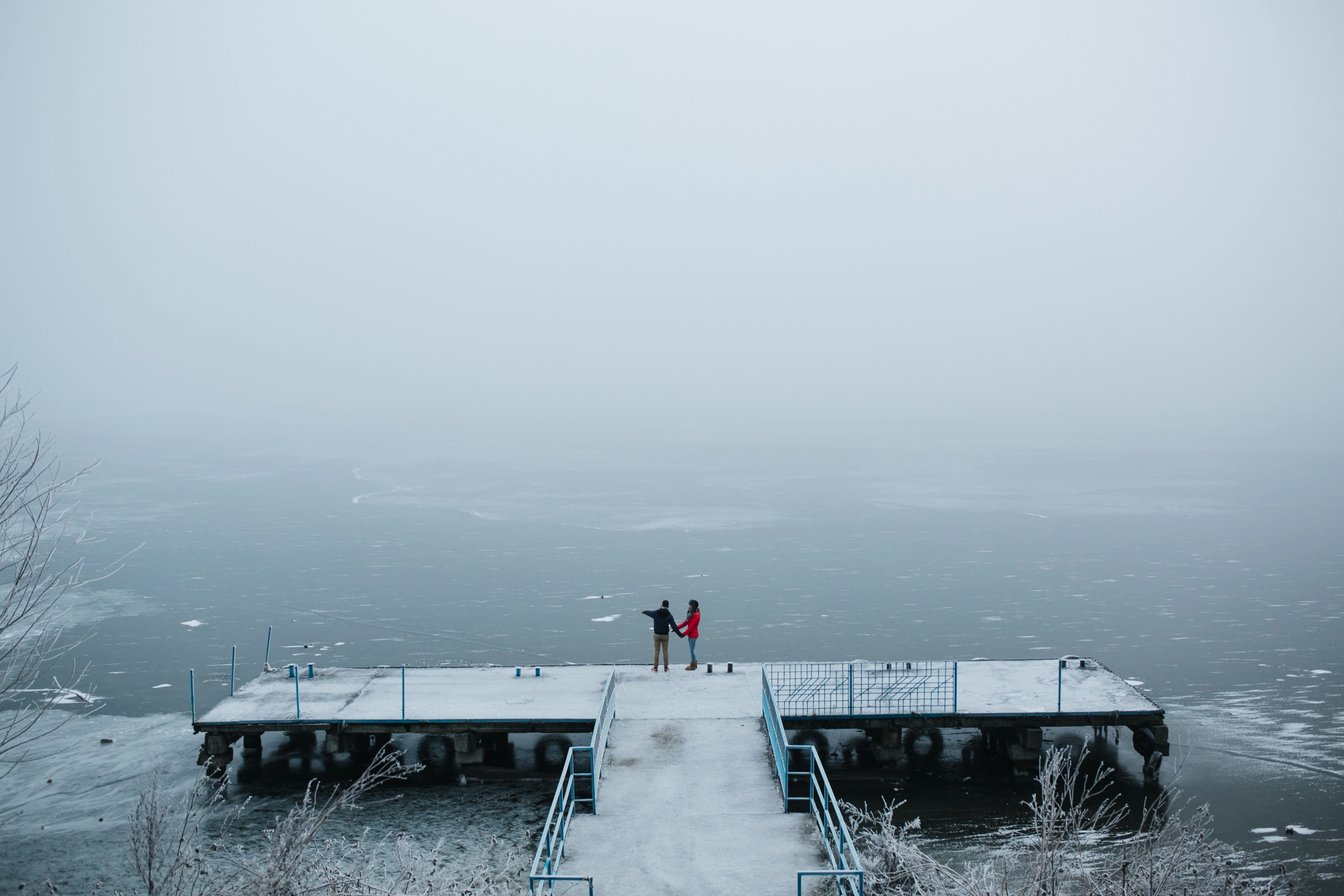 beautiful-young-couple-standing-pier-looks-frozen-lake Explore Antarctica: A Luxury Guide to Experiential Antarctic Expeditions